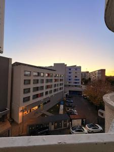 a view of a building with cars parked in a parking lot at Ultracentral 1 Craiova in Craiova