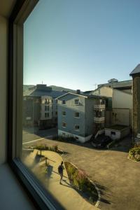 a person standing outside a window looking at a courtyard at Modern Apartment in Tromsø Center in Tromsø +34 photos