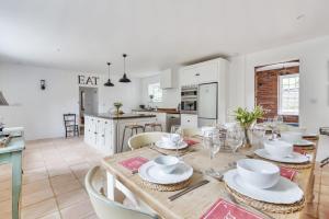 a kitchen and dining room with a table and chairs at The Long Cottage with attic in Flitcham