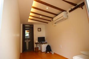 a room with a desk and a computer on the wall at Sungsim Hanok Guesthouse in Jeonju
