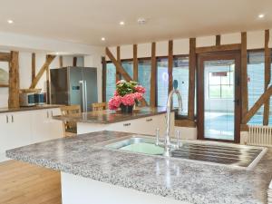 a kitchen with a sink and a counter top at Burfields Barn in Rickinghall