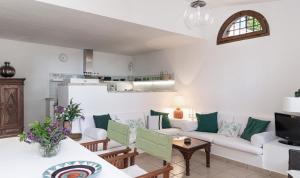a living room with a couch and a table at Villa Fiori 4 in Is Molas 