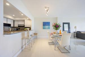 a kitchen and living room with a table and chairs at Ocean Reserve 1524 in Miami Beach