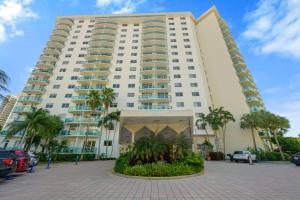 a large white building with palm trees in front of it at Ocean Reserve 1524 in Miami Beach