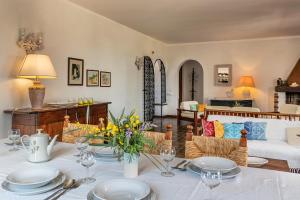 een woonkamer met een tafel met borden erop bij Villa Palme in Monte Nai