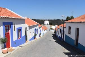 a street in the town ofategoria with colorful houses at Casa Das Batatas in Odeceixe +3 photos