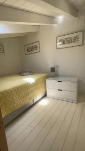a bedroom with a bed and a dresser at Casa Das Batatas in Odeceixe