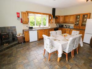 a kitchen with a table and chairs and a stove at Carrowreagh in Aclare