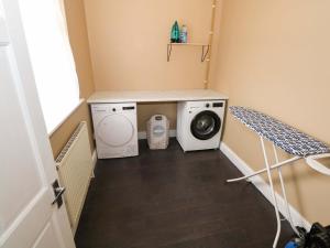 a small laundry room with a washer and dryer at Carrowreagh in Aclare