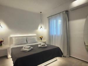 een slaapkamer met een bed met twee handdoeken erop bij Super views in Mykonos in Panormos Mykonos