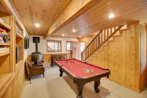 a pool table in a room with wooden walls at Peaceful and Idyllic Forest Cabin with Pool Table in Pine Mountain Club