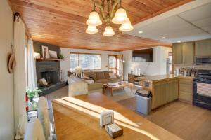 a kitchen and living room with a table and a couch at Peaceful and Idyllic Forest Cabin with Pool Table in Pine Mountain Club