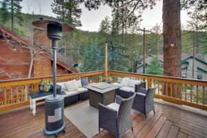 a patio with a table and chairs on a deck at Peaceful and Idyllic Forest Cabin with Pool Table in Pine Mountain Club