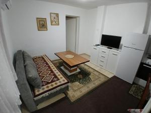 a living room with a couch and a table at Stan na dan Apartman Kozarac in Kozarac