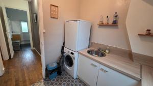 a kitchen with a refrigerator and a washing machine at T2 proche du CH d'Arras in Sainte-Catherine +7 photos