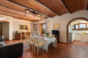 a dining room with a white table and chairs at Villa Aurea - Private Pool & Garden in Tuscany in Canneto