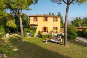 an aerial view of a yellow house with trees at Villa Aurea - Private Pool & Garden in Tuscany in Canneto