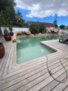 a swimming pool with a hose in a backyard at Black chilli accommodation in Brackenfell