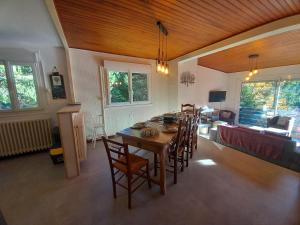 a dining room with a table and chairs at chalet vassivière in Le Lioran