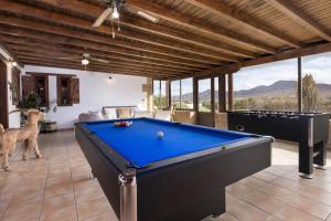 a living room with a pool table and a couch at Home2Book Serenity Villa with Private Pool in Casillas del Ángel