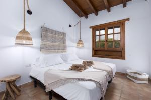 a bedroom with a bed with a stuffed animal on it at Home2Book Serenity Villa with Private Pool in Casillas del Ángel