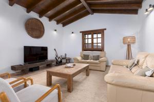 a living room with couches and a coffee table at Home2Book Serenity Villa with Private Pool in Casillas del Ángel