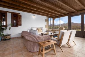 a living room with a couch and chairs and a table at Home2Book Serenity Villa with Private Pool in Casillas del Ángel