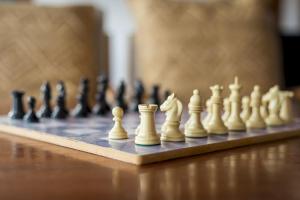 a chess board with white chess pieces on it at Home2Book Serenity Villa with Private Pool in Casillas del Ángel +31 photos