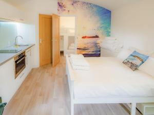 a white room with a white couch and a kitchen at Owl - Uk43447 in Hayle