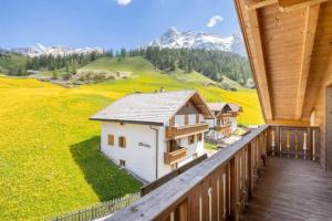 a balcony of a house with a view of a mountain at Family and Wellness Residence Ciasa Antersies in San Cassiano