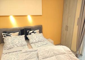 a bedroom with a bed and pillows on it at Amber Apartman in Banja Koviljača +16 photos