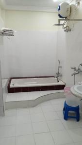 a bathroom with a bath tub and a sink at HOTEL SAPTARSHI in Bānkura