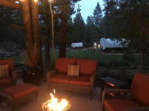 a fire pit with couches and a fire at Family-Friendly Wagon Perfect for a Unique Glamping Experience in Utah in Alton