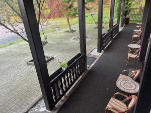 a row of chairs and tables on a porch at Motel Zur Festwiese in Gierstädt