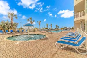 a group of lounge chairs and a swimming pool at Spacious 1 BR Condo-Breathtaking Oceanfront Views! Bay Watch 706 in Myrtle Beach
