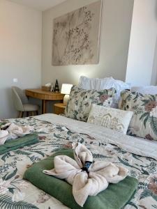 a bedroom with a bed with towels on it at HelloWine Apartman in Eger