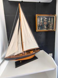 a model of a sail boat on a shelf at Seaview Apartment N12 in El Perelló +20 photos