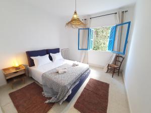 Postel nebo postele na pokoji v ubytování Spric Charming Apartment La Marsa