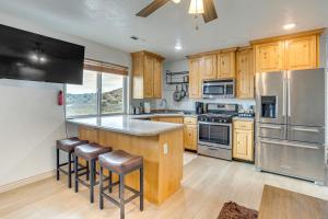 a kitchen with wooden cabinets and stainless steel appliances at Near Dinosaur Natl Monument! High Desert Hideaway in Naples
