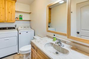 a white bathroom with a sink and a toilet at Near Dinosaur Natl Monument! High Desert Hideaway in Naples +18 photos
