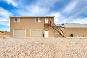 a house with two garage doors and a staircase at Near Dinosaur Natl Monument! High Desert Hideaway in Naples