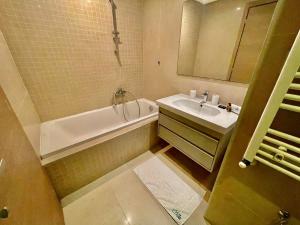 a bathroom with a tub and a sink and a bath tub at NEW bright and luxurious 2 bedrooms in Rd Malaga in Sidi Daoud