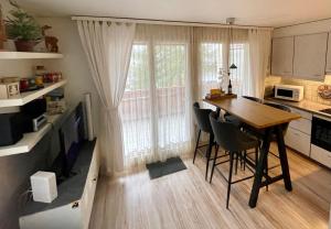 a kitchen with a table and chairs in a room at Ferienwohnung Gemmiblick in Leukerbad