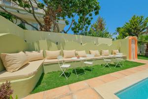 een bank met een tafel en stoelen naast een hek bij Mediterranean Villa with Private Pool in Fethiye