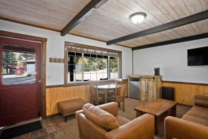 a living room with a couch and a table at Harmels on the Taylor in Almont