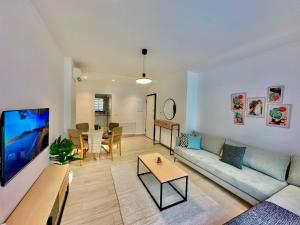 a living room with a couch and a table at Villa Jade appartement neuf avec jardin in Dar el Haj Ahmed Souid