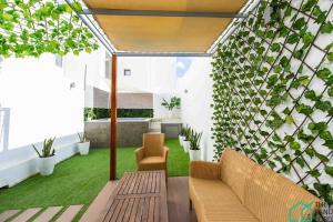 a living room with a couch and some plants at New 1 bedroom with swimming pool next to Lac 2 in El Aouina Station