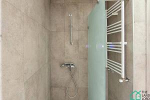 a shower with a shower head in a bathroom at New 1 bedroom with swimming pool next to Lac 2 in El Aouina Station +17 photos