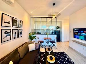 a living room with a couch and a table at C1 Jade new cozy 1 bedroom with garden in Dar el Haj Ahmed Souid