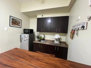 a kitchen with a counter top and a refrigerator at Cozy Staycation at Eastbay Residences in Manila